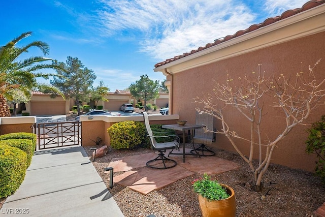 view of patio with a gate and fence