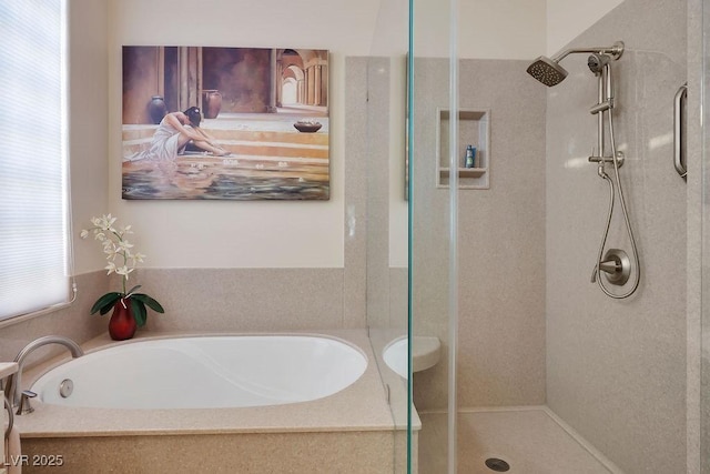 full bathroom featuring a shower stall and a bath