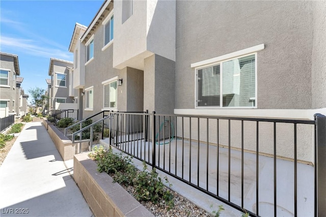 12367 Indigo Montage Rd Unit 3, Las Vegas, NV 89183 - view of exterior entry featuring stucco siding, a residential view, and fence