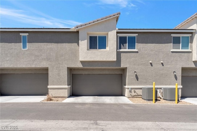 12367 Indigo Montage Rd Unit 3, Las Vegas, NV 89183 - view of front of home with stucco siding, central AC, and a garage