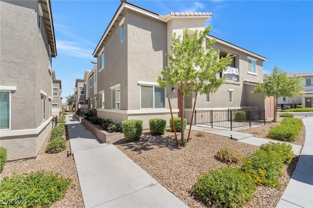 12367 Indigo Montage Rd Unit 3, Las Vegas, NV 89183 - view of home's exterior featuring stucco siding, fence, and a residential view