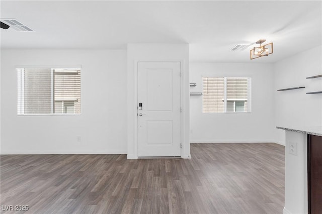 12367 Indigo Montage Rd Unit 3, Las Vegas, NV 89183 - spare room featuring wood finished floors, plenty of natural light, and a chandelier