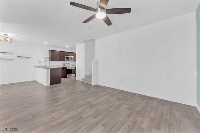 12367 Indigo Montage Rd Unit 3, Las Vegas, NV 89183 - unfurnished living room with recessed lighting, stairs, light wood-type flooring, ceiling fan, and baseboards