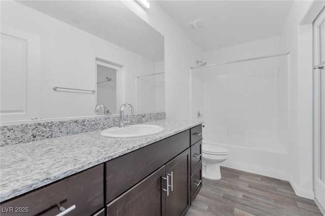 12367 Indigo Montage Rd Unit 3, Las Vegas, NV 89183 - bathroom featuring wood finished floors, vanity, toilet, and shower / washtub combination
