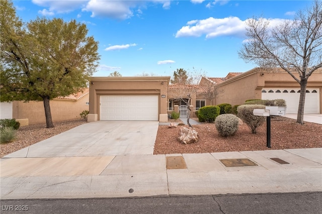 pueblo-style home with stucco siding, driveway, fence, an attached garage, and a tiled roof