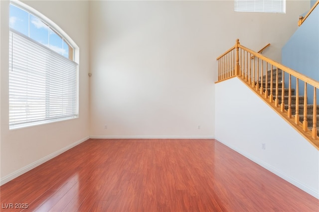 interior space featuring stairs, wood finished floors, and baseboards