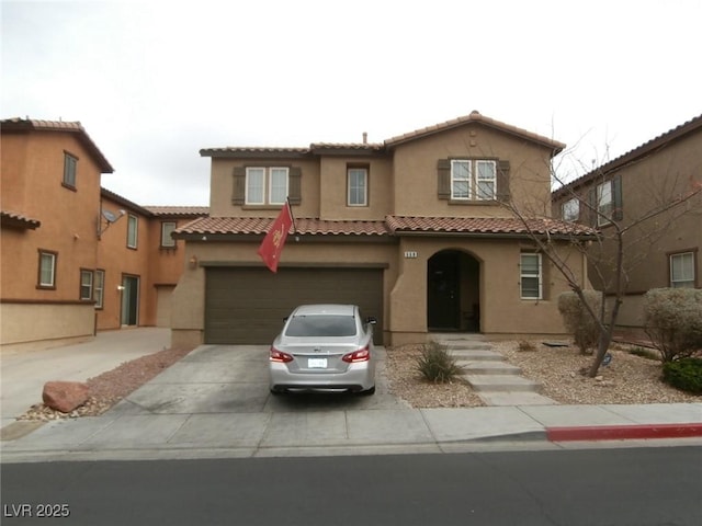 mediterranean / spanish home featuring stucco siding, concrete driveway, an attached garage, and a tiled roof