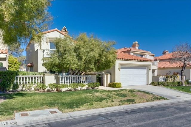 mediterranean / spanish home with stucco siding, a fenced front yard, concrete driveway, an attached garage, and a tiled roof