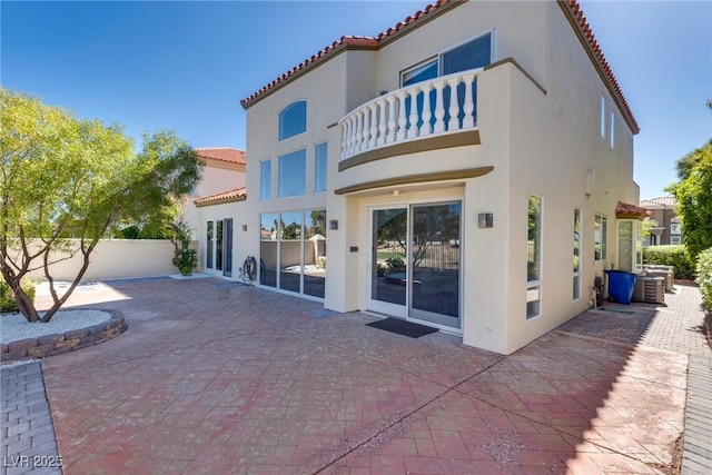 back of property with a patio area, stucco siding, a tiled roof, and fence