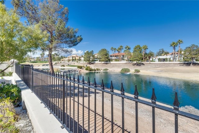 view of pool with a water view and fence