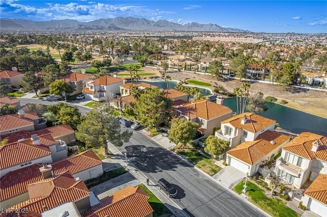 drone / aerial view featuring a residential view and a water and mountain view