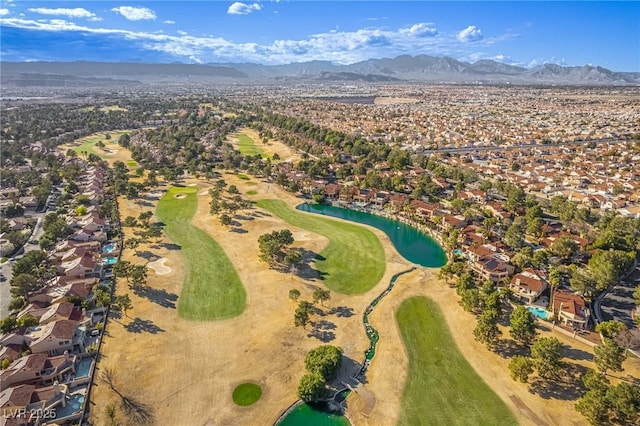 drone / aerial view with golf course view and a mountain view