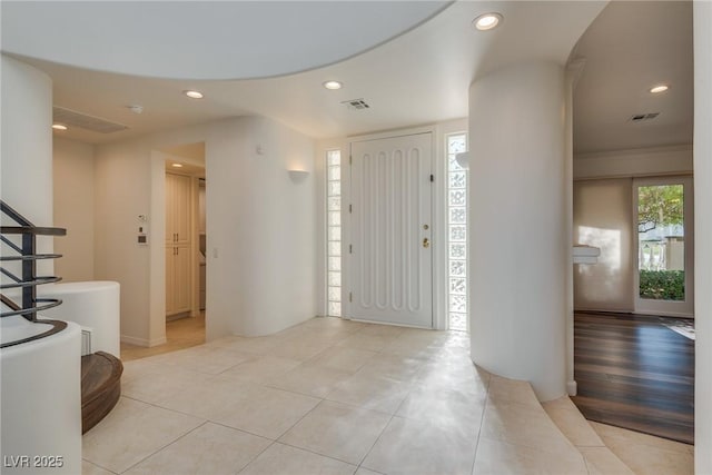 foyer entrance featuring a wealth of natural light, visible vents, and recessed lighting