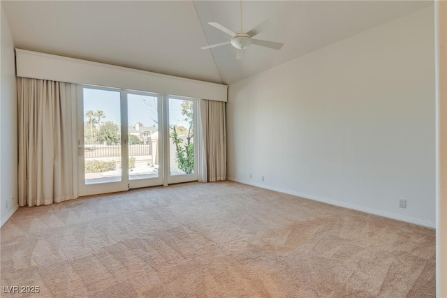 spare room featuring a ceiling fan, baseboards, carpet floors, and high vaulted ceiling