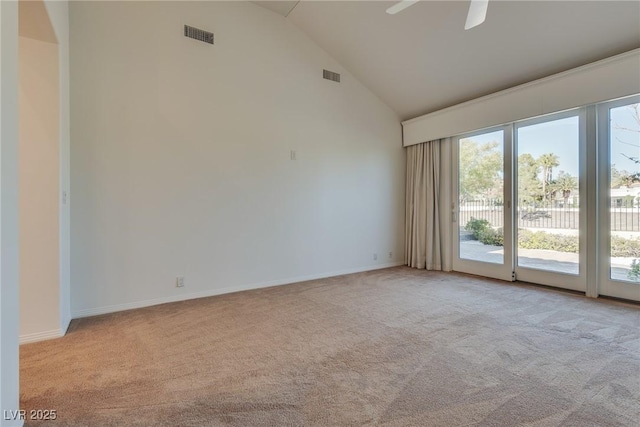 spare room with high vaulted ceiling, a ceiling fan, visible vents, and light carpet