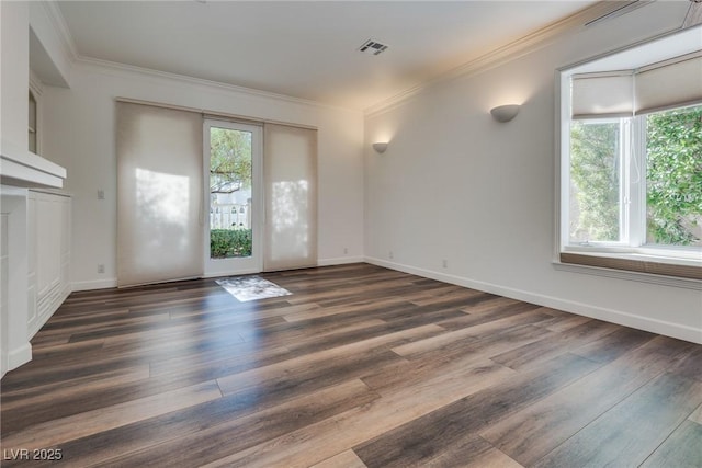 spare room featuring plenty of natural light, visible vents, and dark wood-style flooring