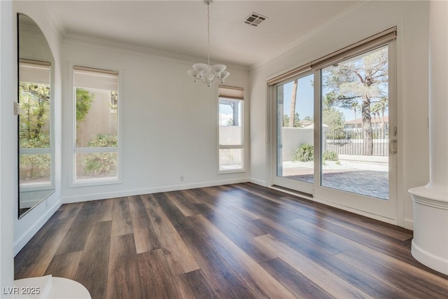 unfurnished dining area featuring visible vents, dark wood-style floors, ornamental molding, and an inviting chandelier