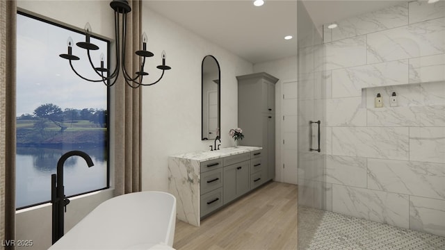 full bath with a stall shower, recessed lighting, wood finished floors, vanity, and a freestanding bath