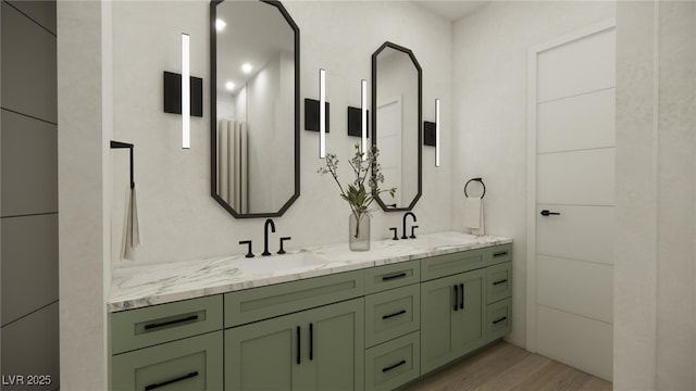full bathroom featuring wood finished floors, double vanity, and a sink