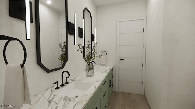 bathroom featuring double vanity, a sink, and wood finished floors