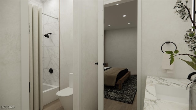 bathroom with recessed lighting, bathtub / shower combination, and wood finished floors