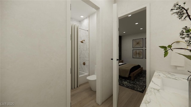 full bath featuring recessed lighting, wood finished floors, toilet, and ensuite bathroom