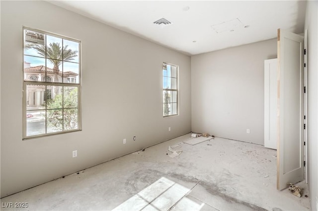 unfurnished room featuring visible vents