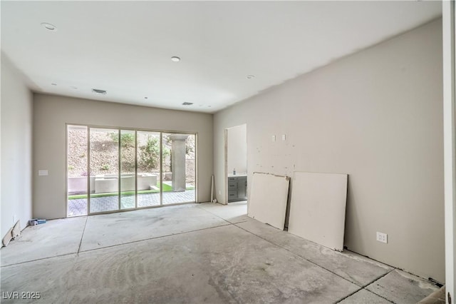 unfurnished room with visible vents and concrete flooring