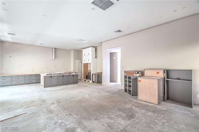 miscellaneous room with visible vents and concrete flooring