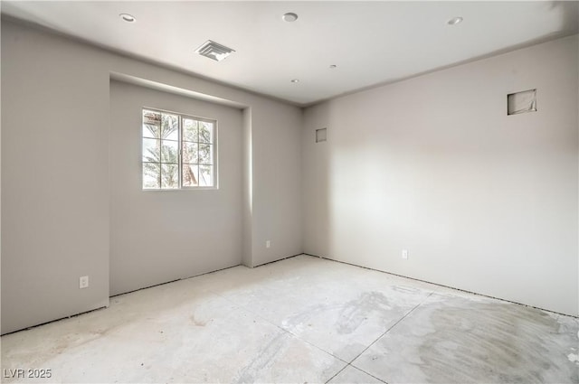 unfurnished room featuring visible vents