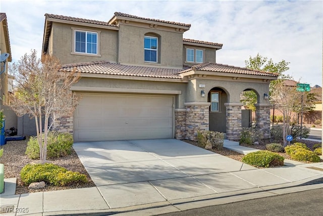 mediterranean / spanish-style house featuring stone siding, stucco siding, driveway, and an attached garage