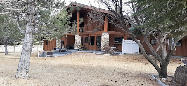 view of front of property featuring fence and board and batten siding