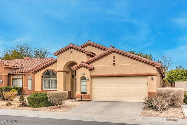 1970 Jasper Creek Pl, Las Vegas, NV 89123 - mediterranean / spanish home with a garage, driveway, stucco siding, and a tile roof