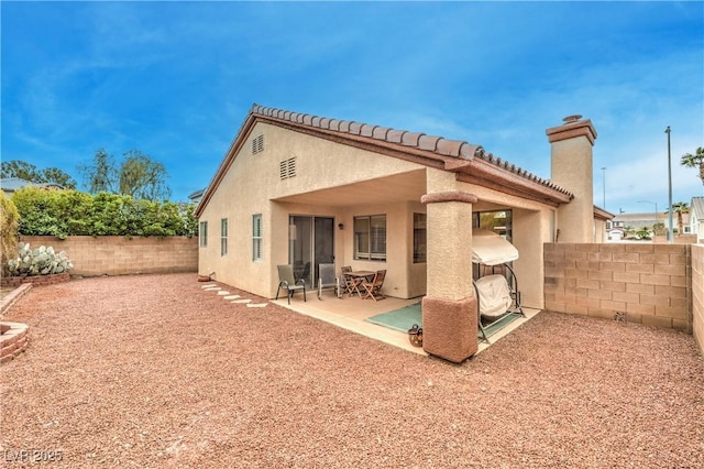 1970 Jasper Creek Pl, Las Vegas, NV 89123 - rear view of house with a fenced backyard, stucco siding, a patio, and a chimney