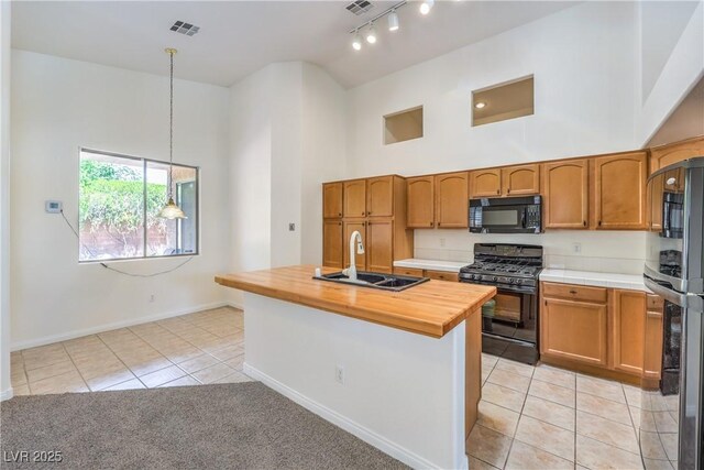 1970 Jasper Creek Pl, Las Vegas, NV 89123 - kitchen with black appliances, light tile patterned flooring, high vaulted ceiling, a sink, and baseboards