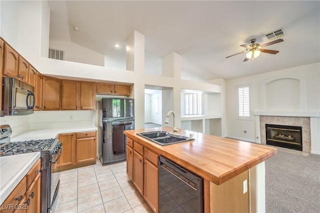 1970 Jasper Creek Pl, Las Vegas, NV 89123 - kitchen with black appliances, a sink, a ceiling fan, a fireplace, and lofted ceiling