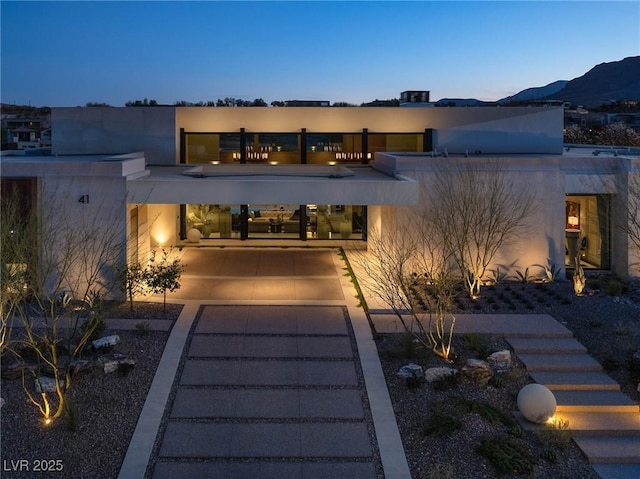 view of front of house featuring stucco siding and a mountain view