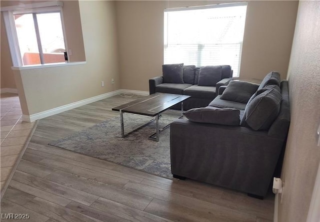 living area featuring wood finished floors and baseboards