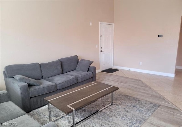 living area featuring baseboards and wood finished floors