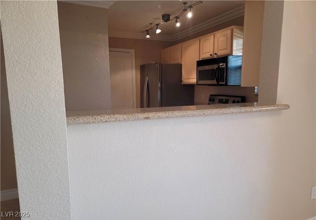 kitchen with track lighting, light brown cabinets, stainless steel microwave, freestanding refrigerator, and crown molding