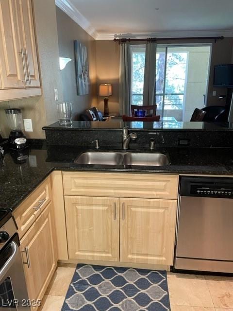 kitchen with ornamental molding, a sink, dark stone countertops, appliances with stainless steel finishes, and light tile patterned flooring