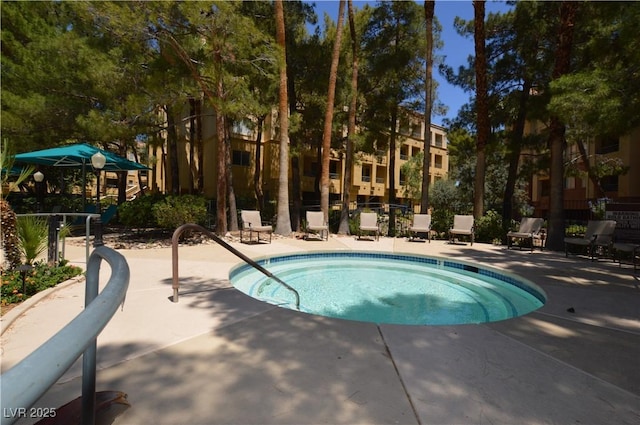 view of pool with fence, a pool, and a patio area