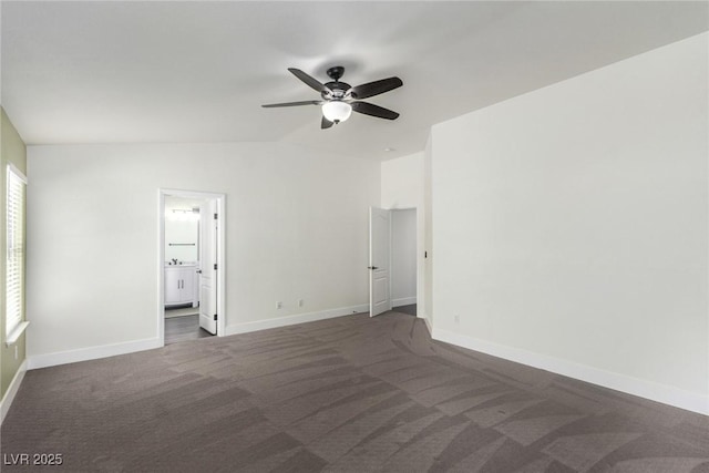 carpeted empty room featuring baseboards, lofted ceiling, and ceiling fan