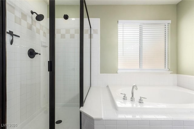 full bathroom featuring a shower stall and a garden tub