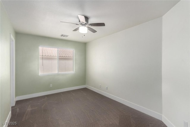 unfurnished room featuring dark colored carpet, visible vents, baseboards, and a ceiling fan