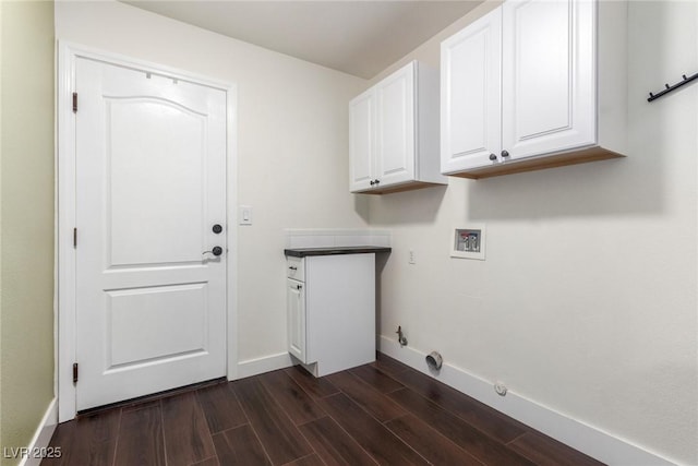 laundry room featuring dark wood-style floors, cabinet space, baseboards, gas dryer hookup, and hookup for a washing machine