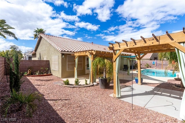 rear view of house with stucco siding, a patio, a fenced backyard, and a pergola