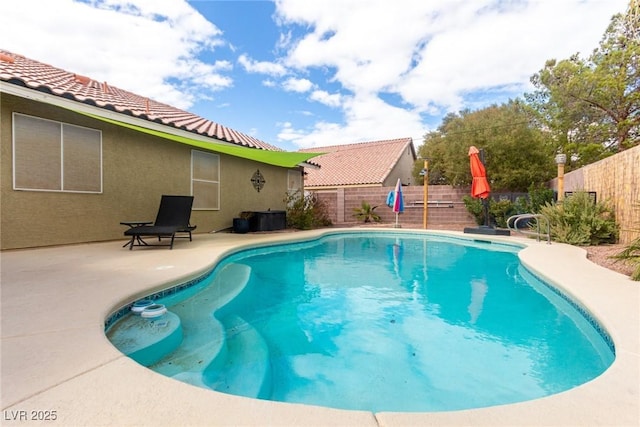 view of swimming pool featuring a patio area, a fenced backyard, and a fenced in pool