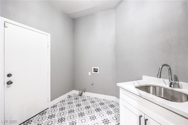 laundry room with cabinet space, hookup for a washing machine, baseboards, and a sink