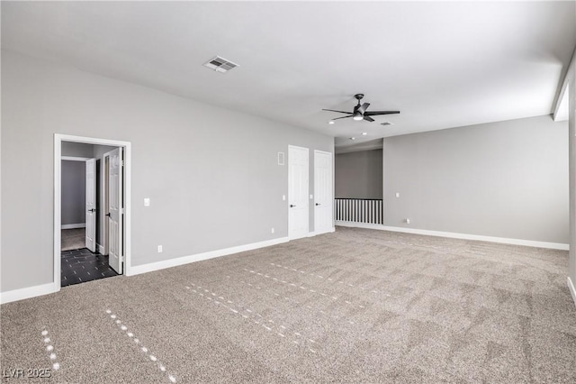 unfurnished room featuring visible vents, carpet flooring, and baseboards